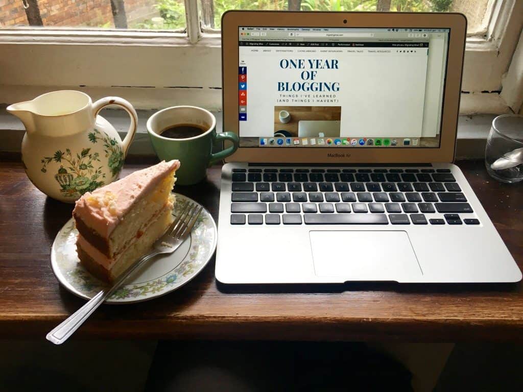 Laptop with cake and coffee in a cafe