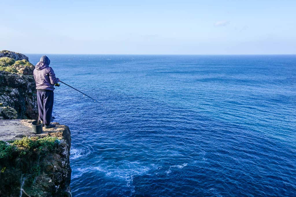 Sagres Fisherman on cliff Algarve Portugal