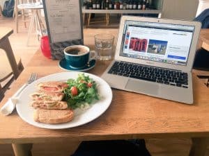 How to Find your Blogging Niche - Laptop on a table with sandwich lunch and coffee
