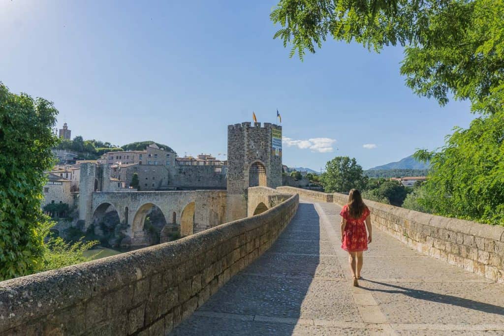 How to choose a country to move to - walking across a bridge in Spain