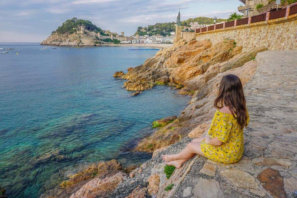 How to Find your Blogging Niche - Sitting on rocks at seaside