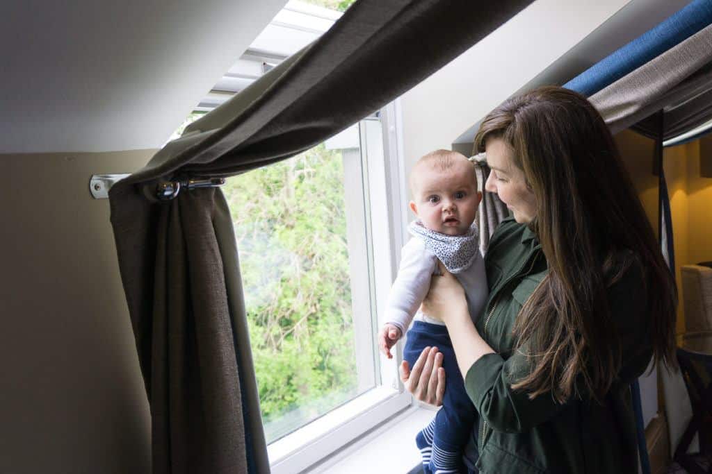 Mum holding Baby in window