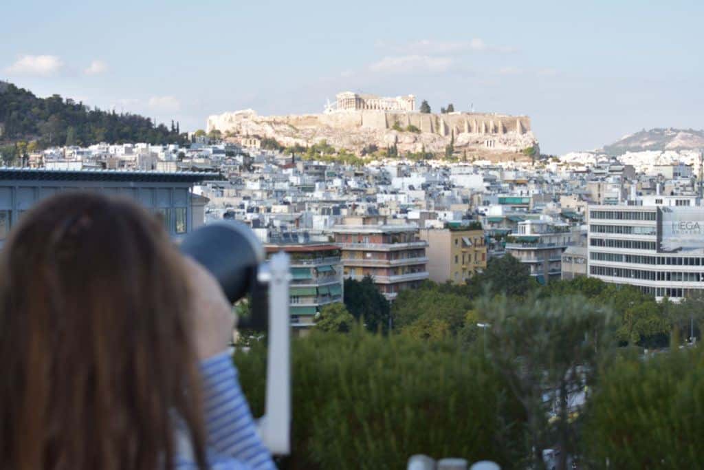 Babymoon Destinations Europe - Athens - Woman taking a photo of Acropolis from a distance