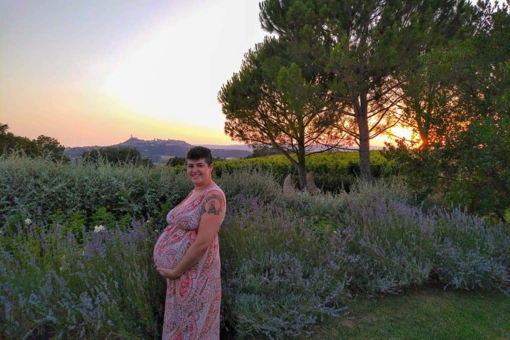 Babymoon Destinations Europe - Umbria Pregnant woman in front of lavender and sunset