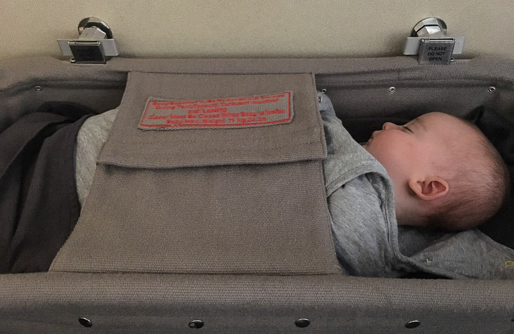 Baby in plane bassinet