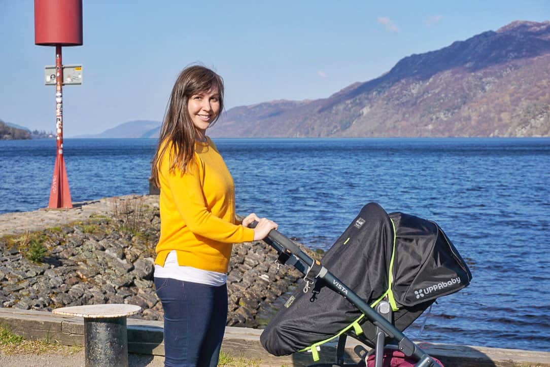 Mum with baby in pram in front of lake
