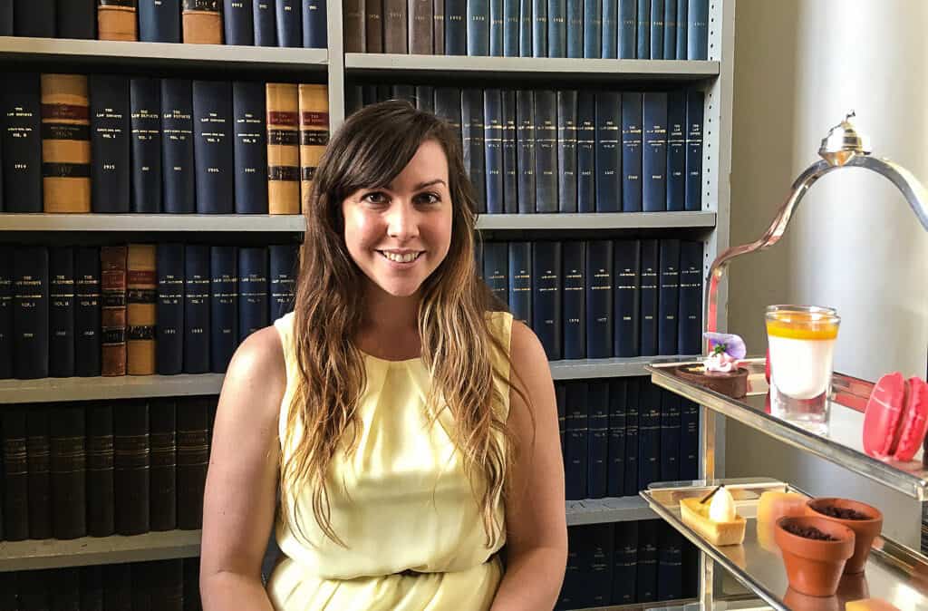 Sitting at afternoon tea with law books behind