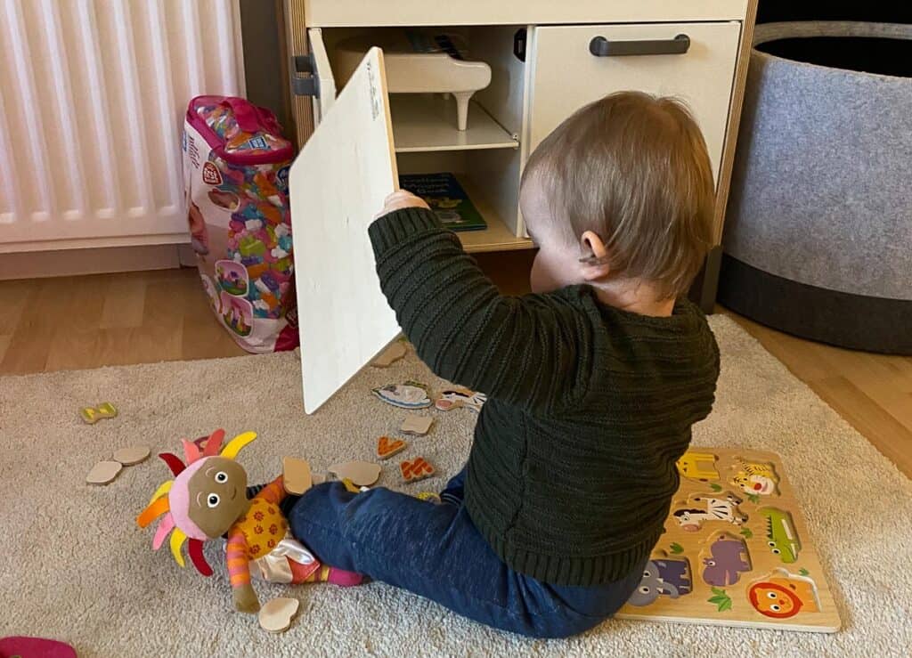 Working from home with a toddler - set up activity stations - baby with puzzle