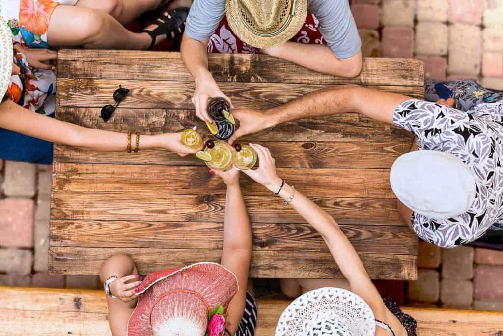 Edinburgh Beer Gardens - Friends doing cheers around a wooden table