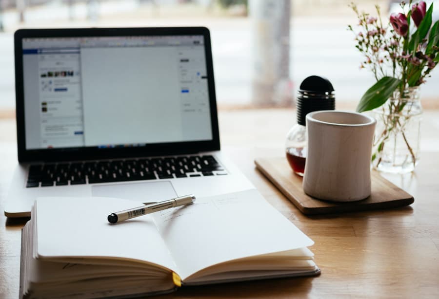 Laptop with notebook and coffee - writing for the web