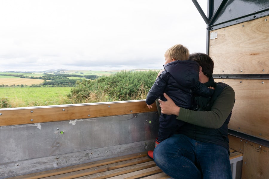 Jackons at Jedburgh - Toddler and father on trailer overlooking farmland