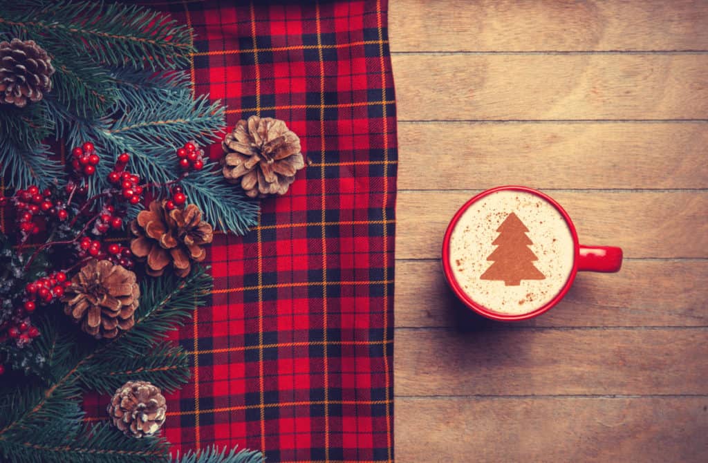 Tartan and pine cones on the table, cappuccino on the table-a Scottish Christmas tradition