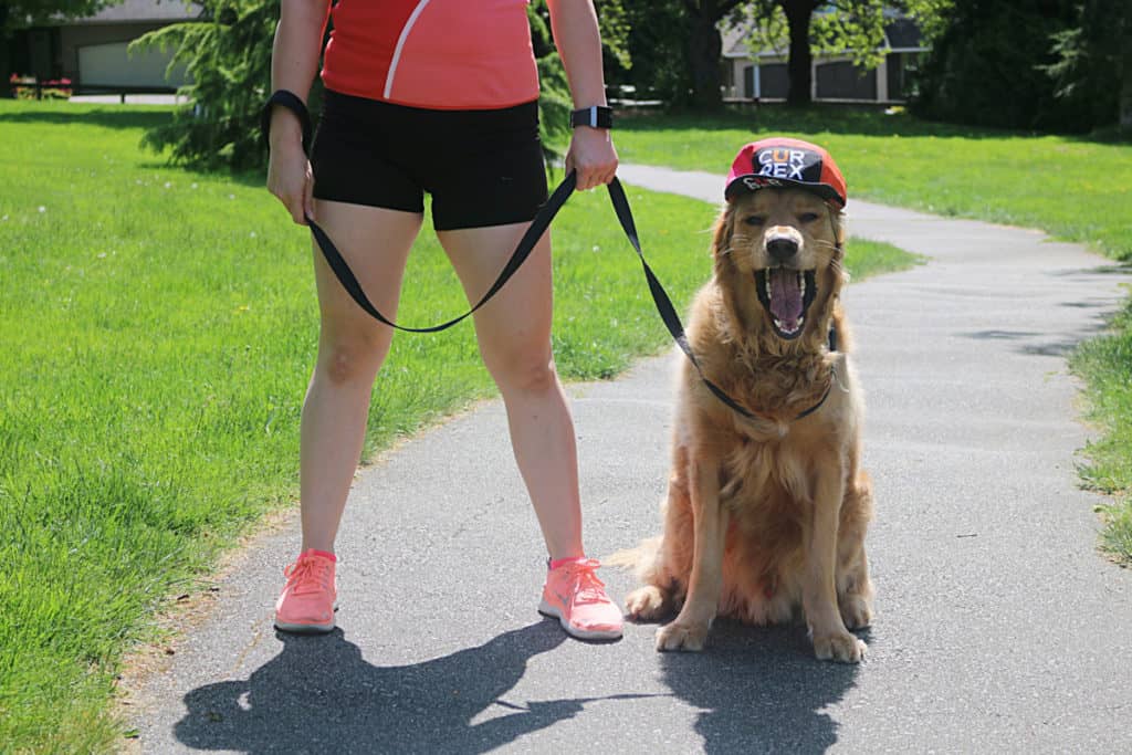 Product photo with woman in gym gear and dog in hat