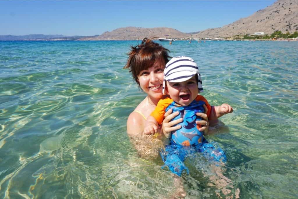 Best Greek Islands for Families - Mum and Baby swimming at beach in Greece